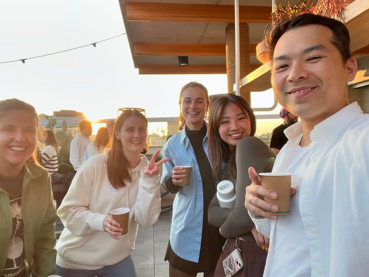 Golden-hour rooftop selfie with the team